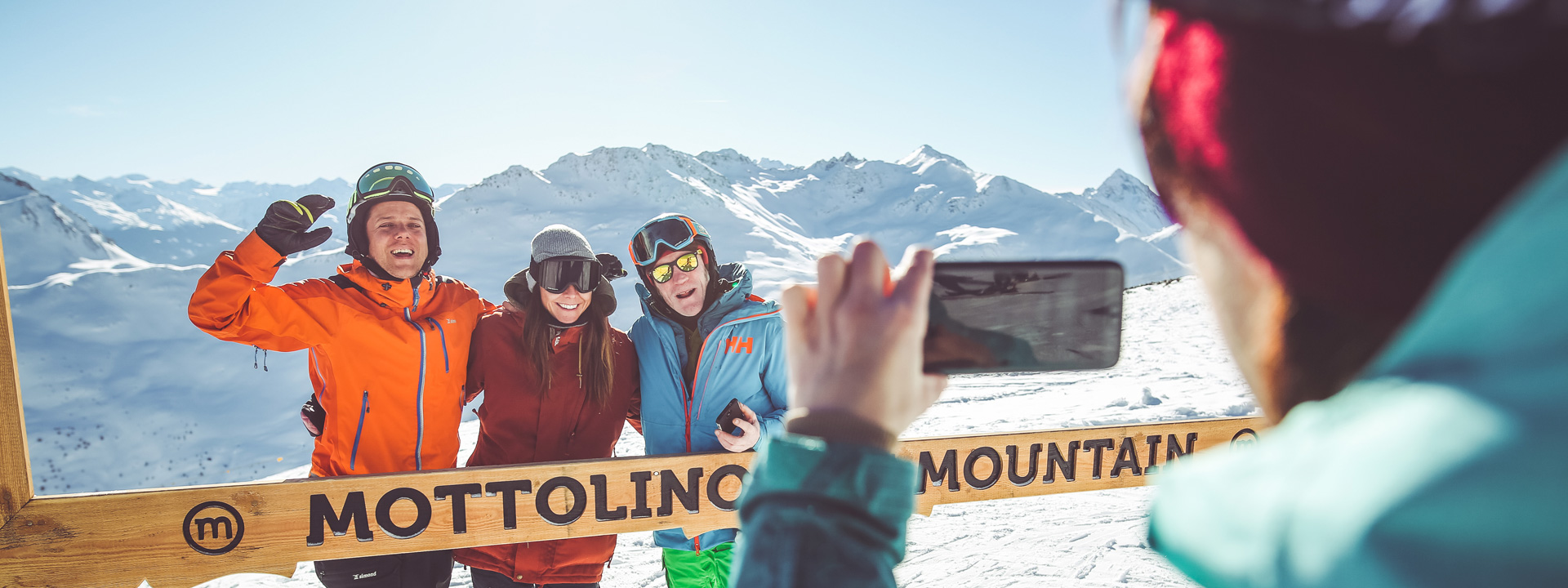 Gruppo di amici che si fanno una foto in cima alla ski area Mottolino a Livigno